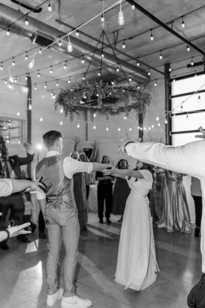 Black and White photo of couple dancing after their ceremony in White Barn.