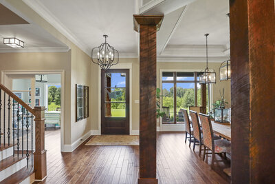 entryway with large wooden pillars and wooden floors