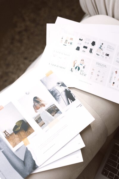 Display of style guide and LTK printed materials laid on a couch, showcasing meticulous attention to design details.