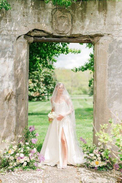 A bride at Gwyn Careg Inn standing under a doorway.  