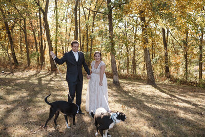 candid wedding photo of a bride and groom with their dogs