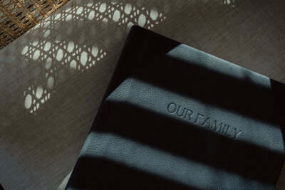 Heirloom photo album with debossed cover on soft bedding, designed to preserve family memories by JPF Galleries.
