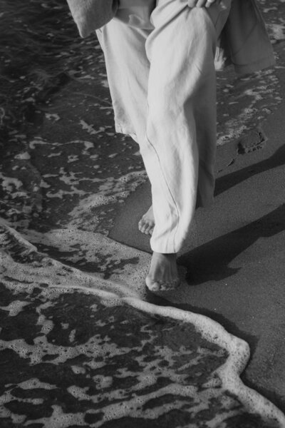 foot walking along the beach