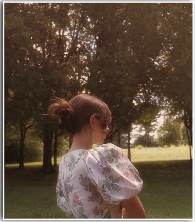 woman in vintage dress stands in field in maryville, tennessee