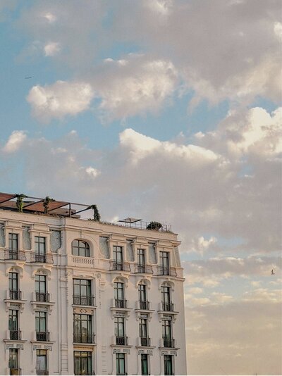 Hotel rooftop surrounded by soft, moody clouds.
