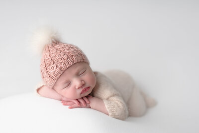 A dreamy newborn portrait with soft textures and cozy winter tones, perfect for celebrating your baby’s first days.
