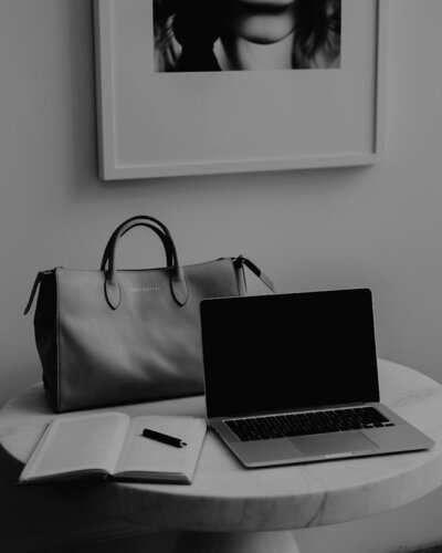 Laptop, notebook, and leather tote on marble table – Effortless Web Design