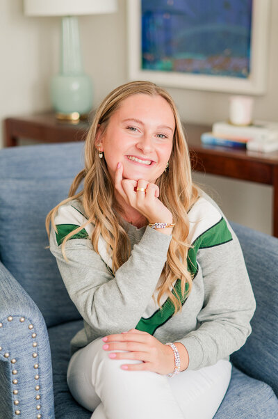 girl smiling in a white blouse and blue jeans