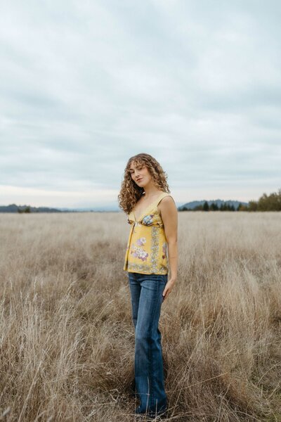 A person dancing as they walk down the aisle of a consignment store 