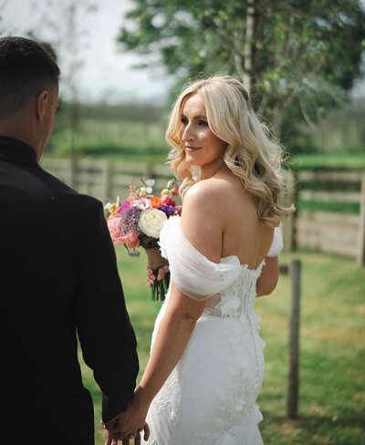 Bride with blonde wavy hair and colourful flowers 