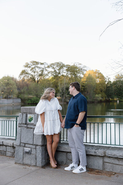 A couple looks at each other on an Atlanta bridge