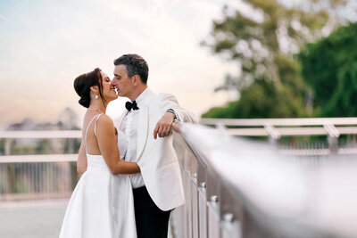 Couple walking hand-in-hand along the Brisbane Riverwalk at sunset — candid and romantic Brisbane wedding photography.