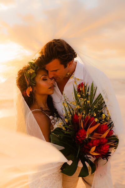 intimate maui wedding photoshoot featuring bride and groom under veil