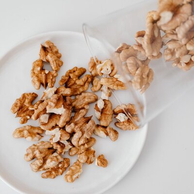a cup of walnuts on a plate