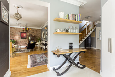 Stylish entryway with a console table and shelves in a modern home.