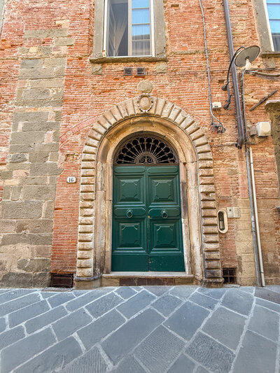 Front door to the building at the Guinigi Apartment in Lucca, Italy