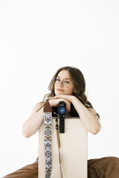 videographer leans on wood block with camera