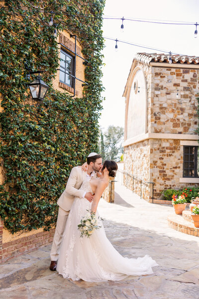Groom Kissing Bride at Bella Collina Orlando, Fl, taken by wedding photographer in Orlando, Blak Maire