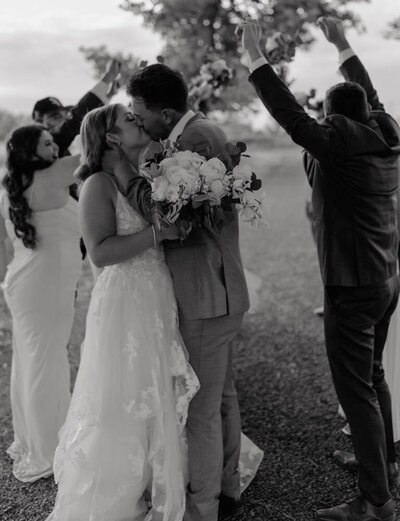 A bride and groom share a romantic kiss on their wedding day, captured in a timeless and cinematic moment in Washington.