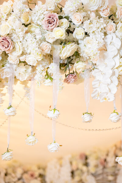 White hanging florals for a wedding reception