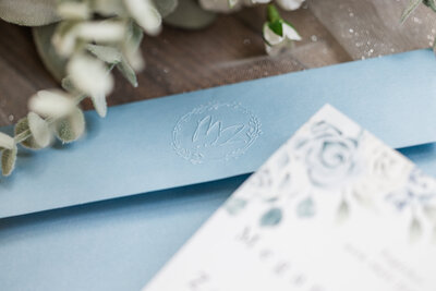 Close up of wedding invitation set for an intimate lakeside wedding.