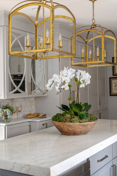 Dove grey kitchen design with warm brass fixtures.