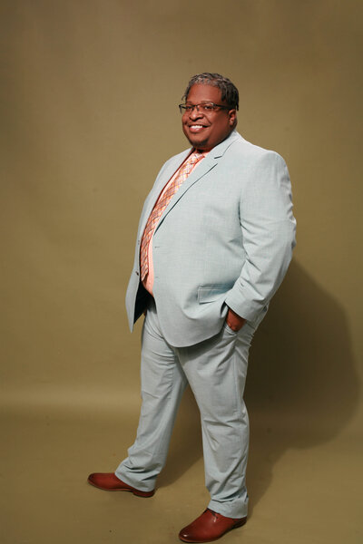 a black male mental health speaker in Massachusetts smiling to the camera