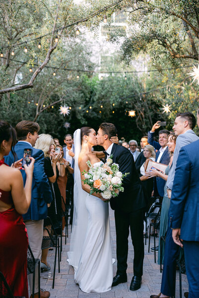 bride and groom kiss in the aisle after saying "i do" at their wedding at Redbird in Los Angeles captured by los angeles wedding photographer magnolia west photography