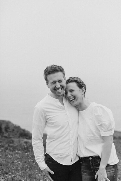 black and white image couple embracing laughing