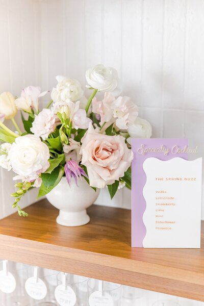 Floral arrangement and pastel bar menu