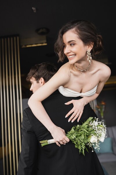 groom-in-black-formal-wear-lifting-joyful-bride-in-2024-11-14-00-42-11-utc