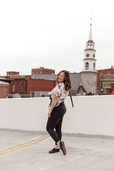 woman standing on rooftop posing