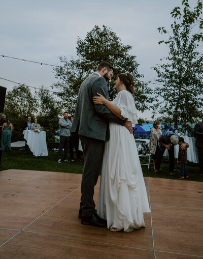 A bride and groom share their magical first dance, surrounded by warm lighting and romance, captured at a wedding in Spokane, Washington.