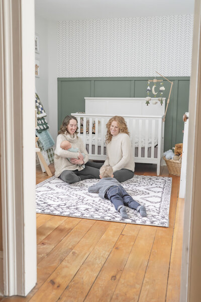 Lifestyle newborn photography session with dad holding baby's toes — captured by Alliston and Barrie maternity, newborn, and family photographer.