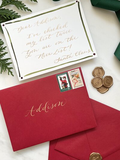 Letter from Santa Claus on white card and  red envelope with gold calligraphy