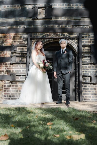 Bride and groom portrait in a stonewall background