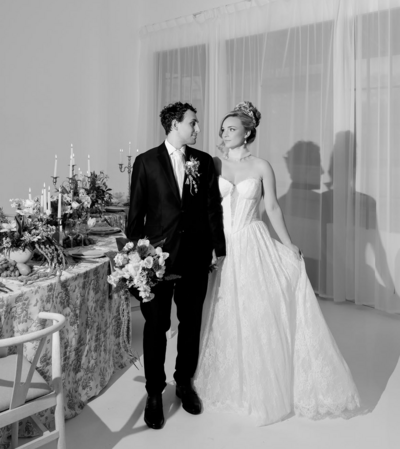 A bride and groom looking at each other at their wedding reception.