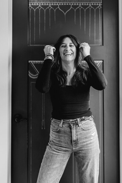 Chelsea owner of The collective Beauty & Wellness hair salon in Eugene laughs facing the camera.