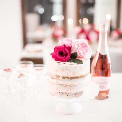 Cake with flowers and sparkling rose wine