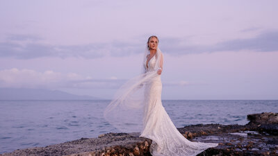 bride on the jetti at the olowalu plantation house in Lahaina maui Hawaii, lace gown and cathedral length veil