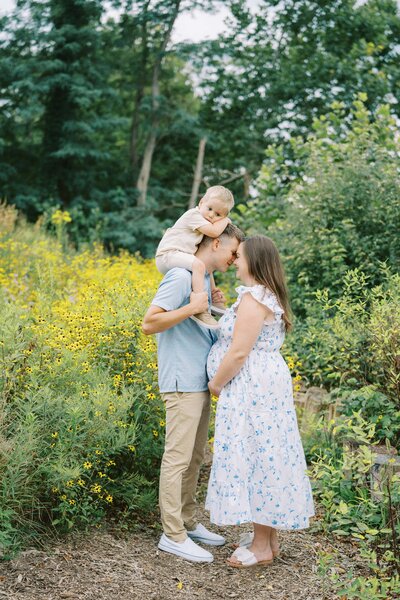 family standing together for maternity photos
