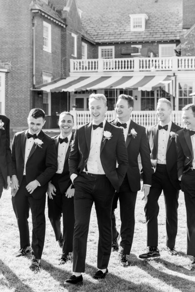 New England wedding groom and groomsmen walking shot by destination wedding photographer Dana Cubbage.