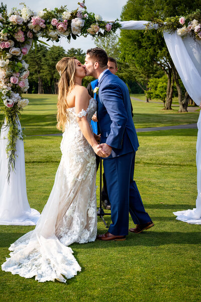 Couple under arbor in DC wedding spring