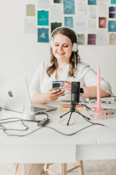 Emily Foster, a website designer and brand designer for wedding pros, looking at a laptop