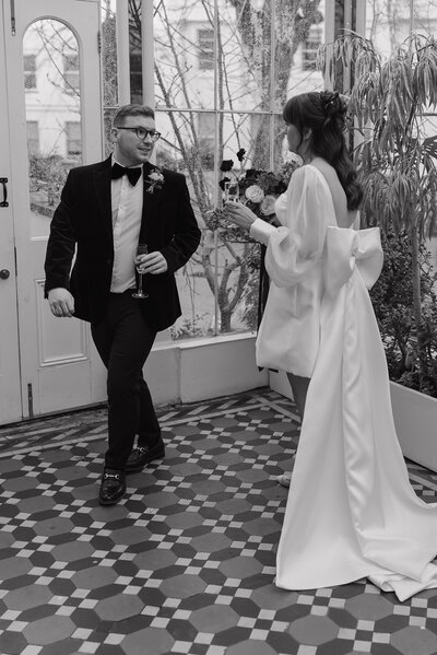 Wedding photographer captures couple taking a stroll hand in hand at their french chateau wedding.