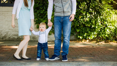 A family soaking in the spring sunshine surrounded by blooms during their photography mini session in Phoenixville.