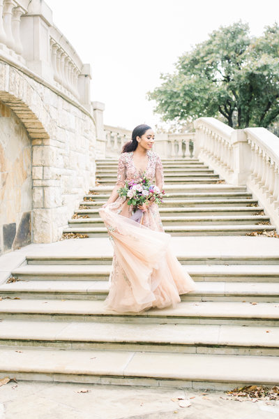 Bride walks down staircase  of William Aiken House in South Carolina by Karen Schanely.