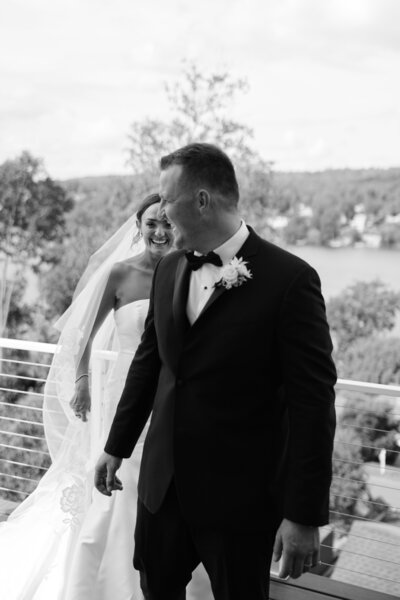 Bride and groom posing outdoors with mountains in the background