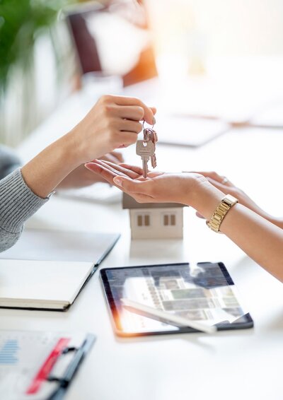 Image of a realtor handing the keys over to the buyer after closing  ona rental property