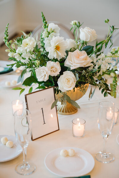 Wedding floral arrangement with vibrant blooms and cascading greenery by Leigh Florist, creating a stunning focal point for the reception